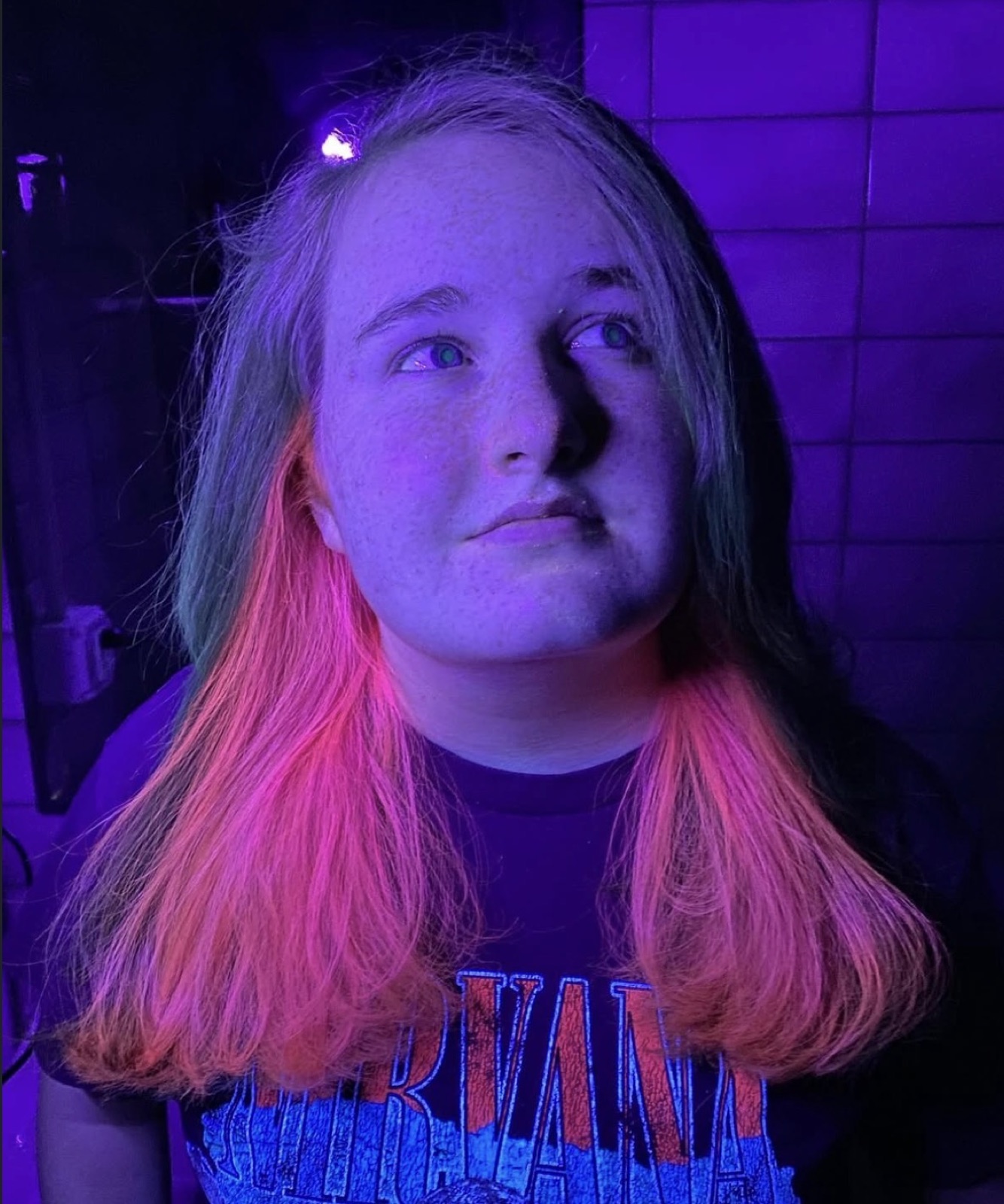 Neon pink hair glowing under blacklight