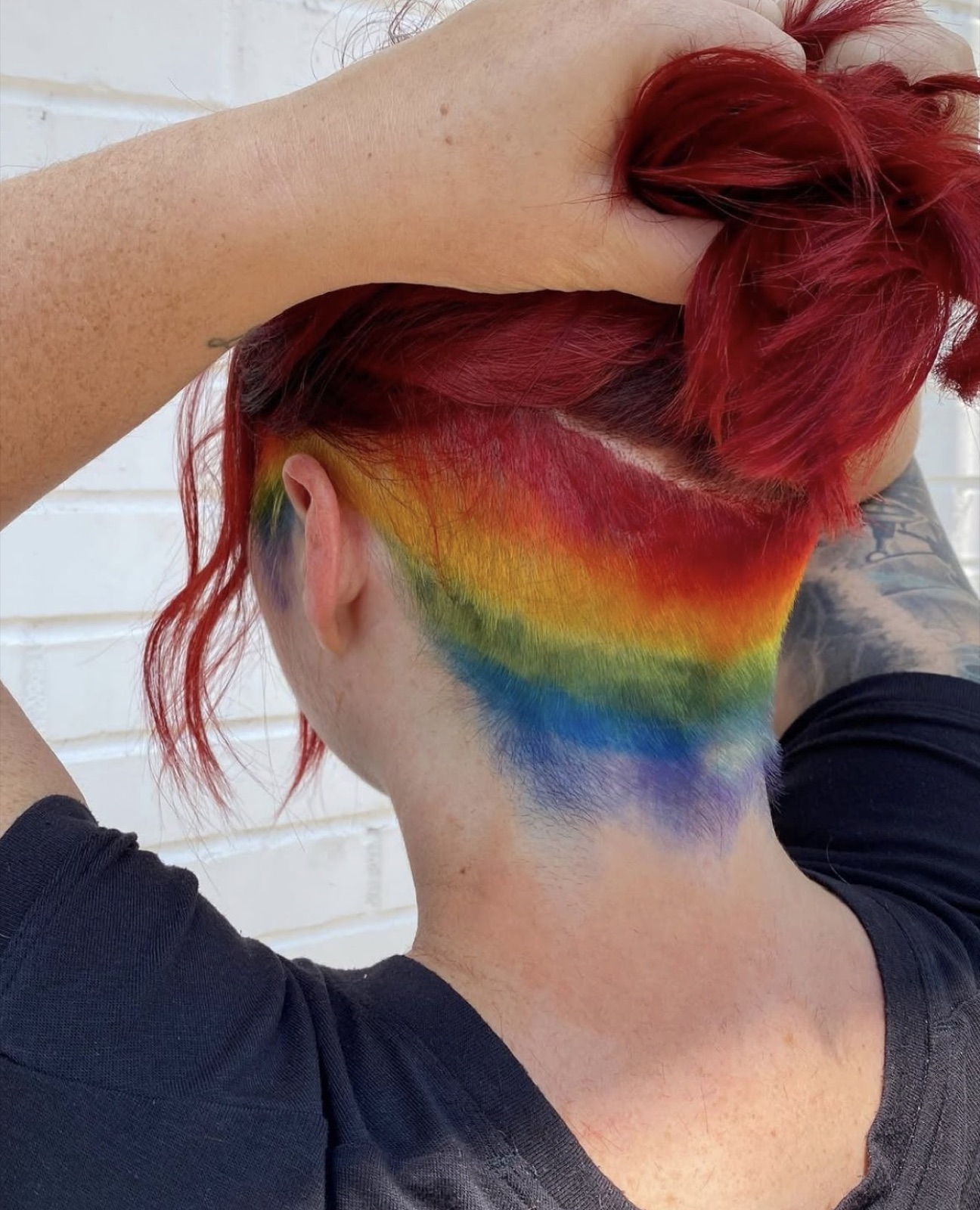 Hidden rainbow undercut at nape under red hair